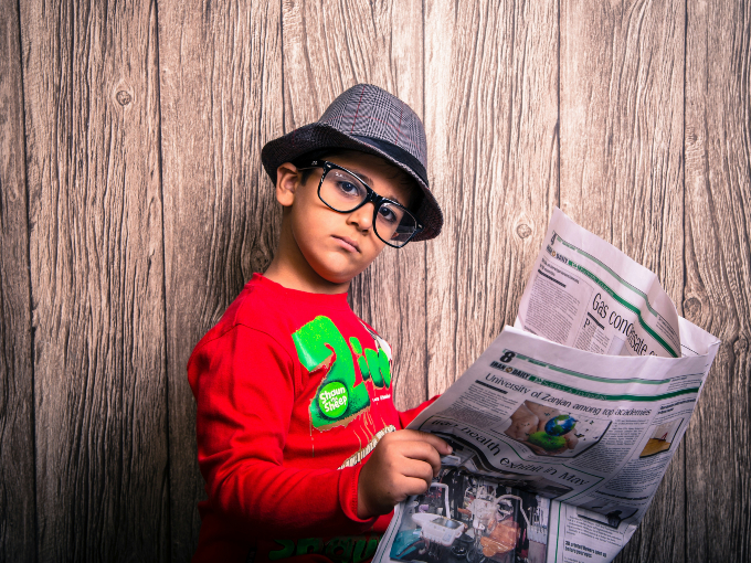 A child reading a newspaper